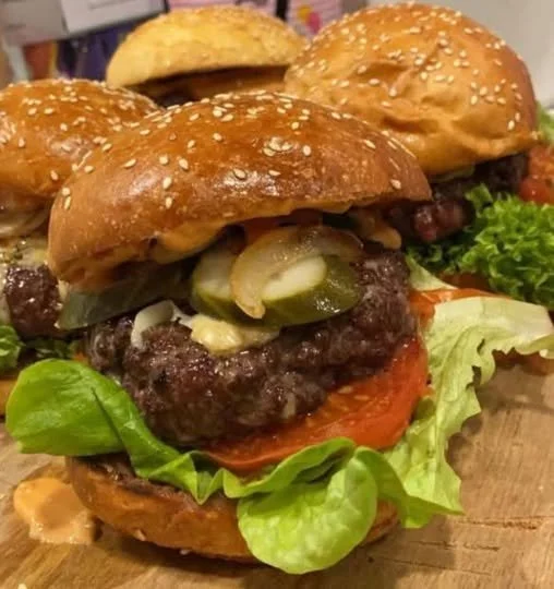 Juicy homemade beef burger topped with fresh vegetables and condiments