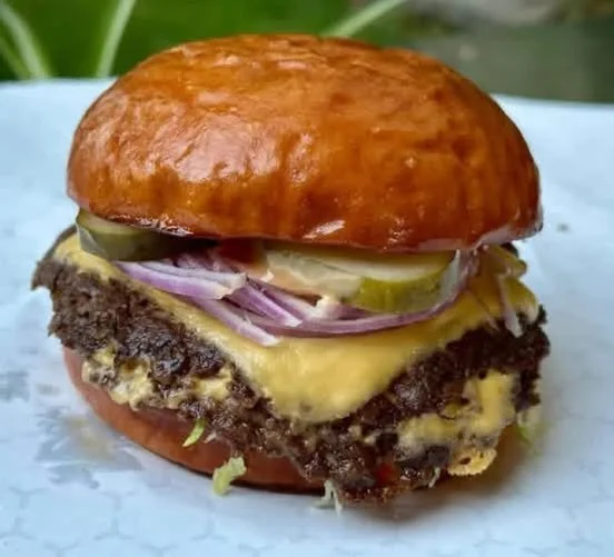 Smash Burger Delicious Smash Burger with toppings and melted cheese on a bun