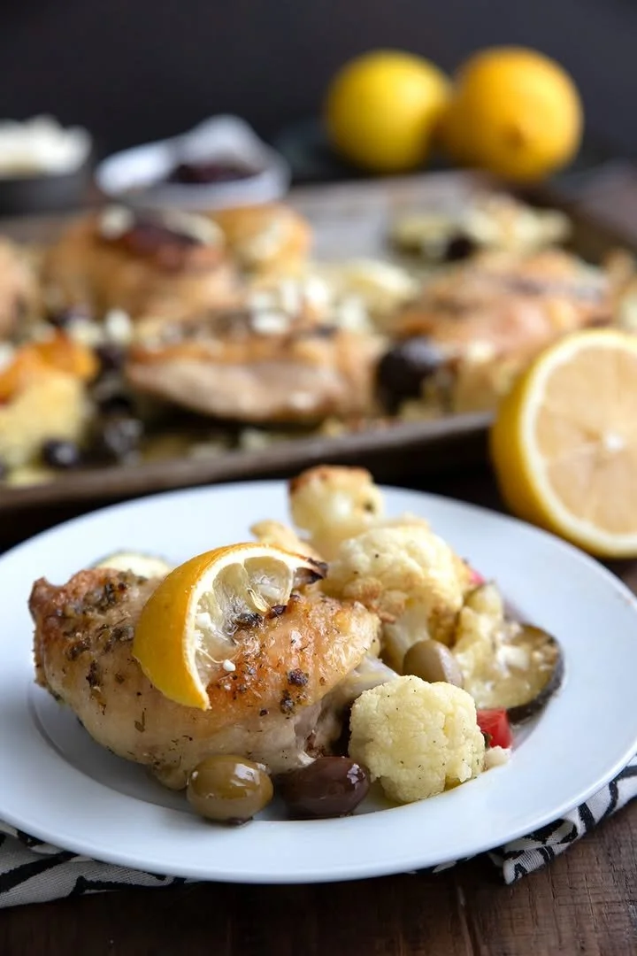 Keto Greek Lemon Chicken Healthy Keto Greek Lemon Chicken served with fresh herbs and lemon slices.