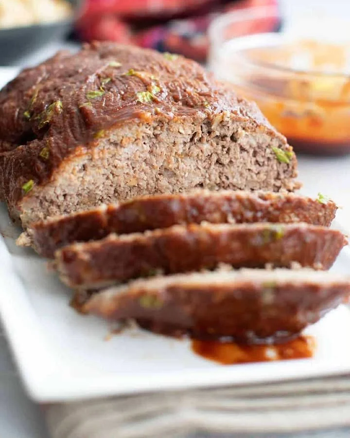 Keto Meatloaf served with a side of vegetables on a white plate