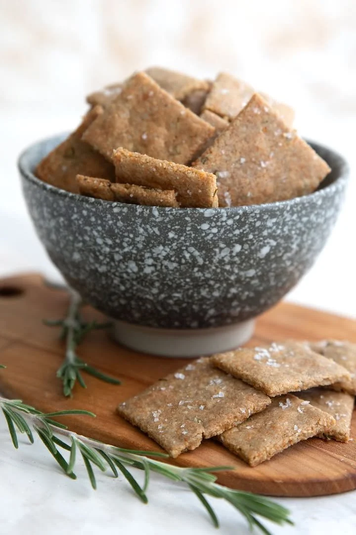 Plate of homemade Keto nut-free crackers on a wooden table