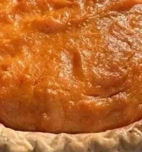 Delicious homemade sweet potato pie topped with whipped cream