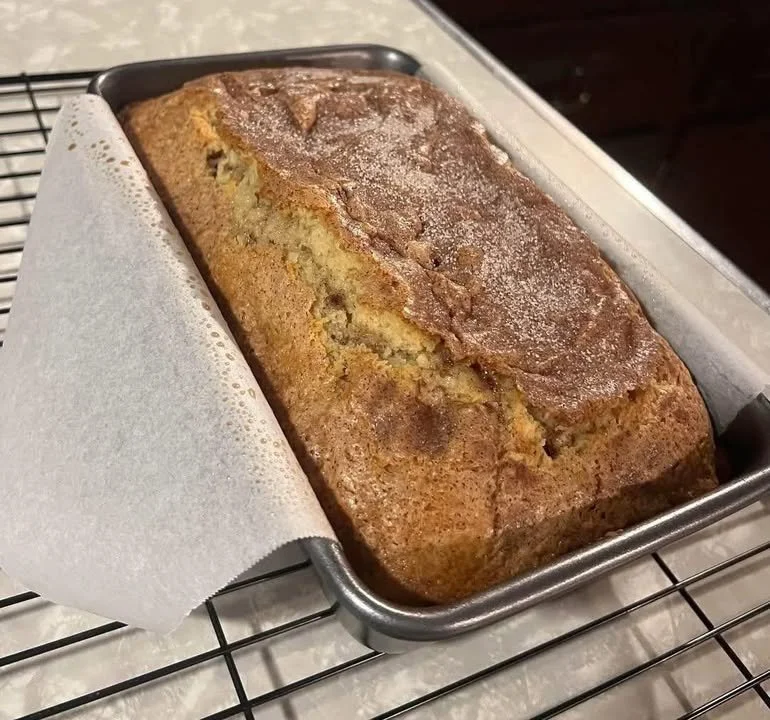 Loaf of freshly baked Amish Cinnamon Bread with cinnamon swirl