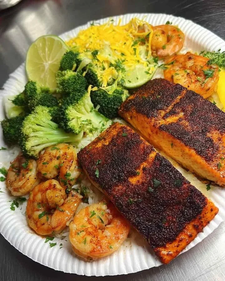 Blackened Salmon Plate with Cheesy Broccoli & Garlic Shrimp Blackened salmon plate served with cheesy broccoli and garlic shrimp