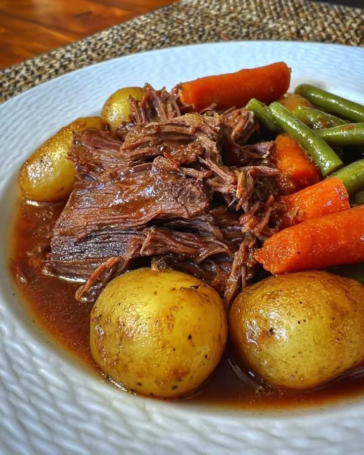 Healthy Slow Cooker Pot Roast Healthy slow cooker pot roast with vegetables in a serving dish