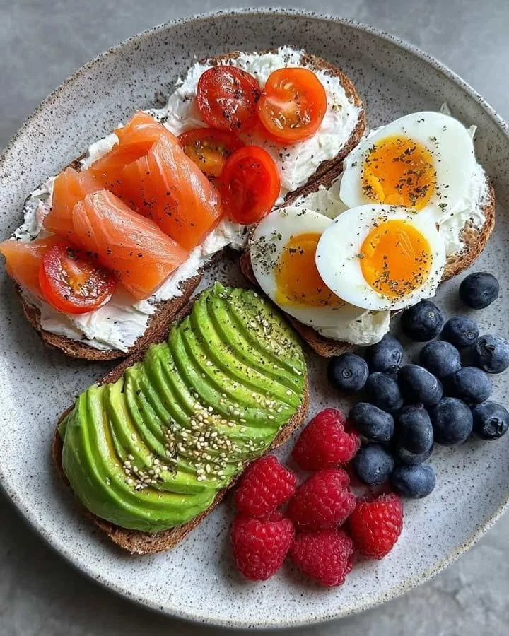 Balanced brunch plate featuring salmon, jammy egg, and fresh berries